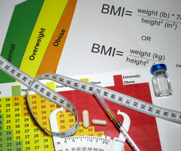 photo of bmi sheets, medication, and ruler