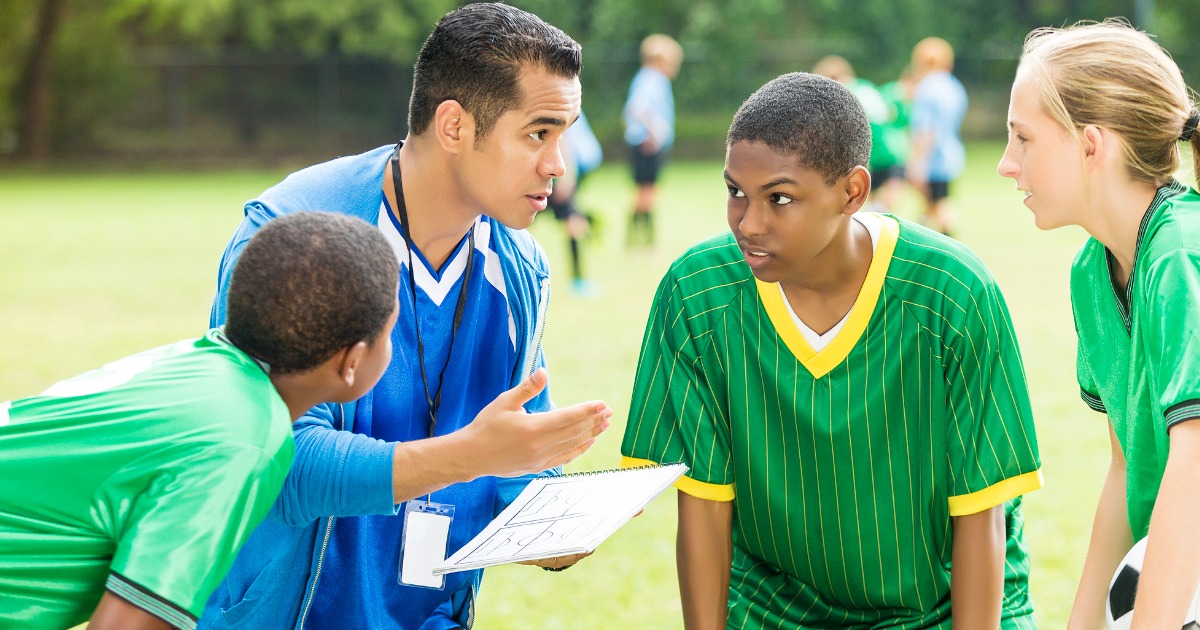 Coach talks to his players
