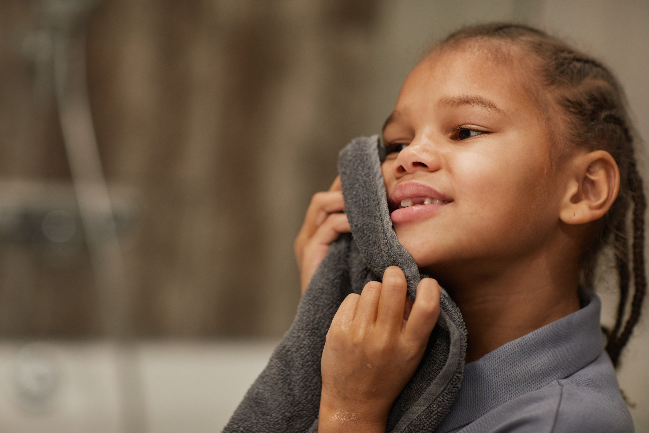 Girl cleaning ear safely with cloth