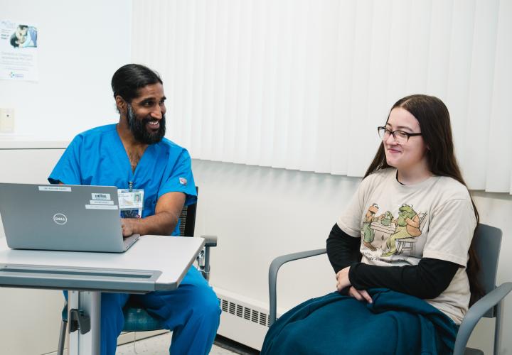 A pain and palliative care doctor interviews a patient in clinic.