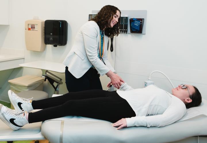 Dr. Bennett examines a patient in Adolescent Medicine clinic.